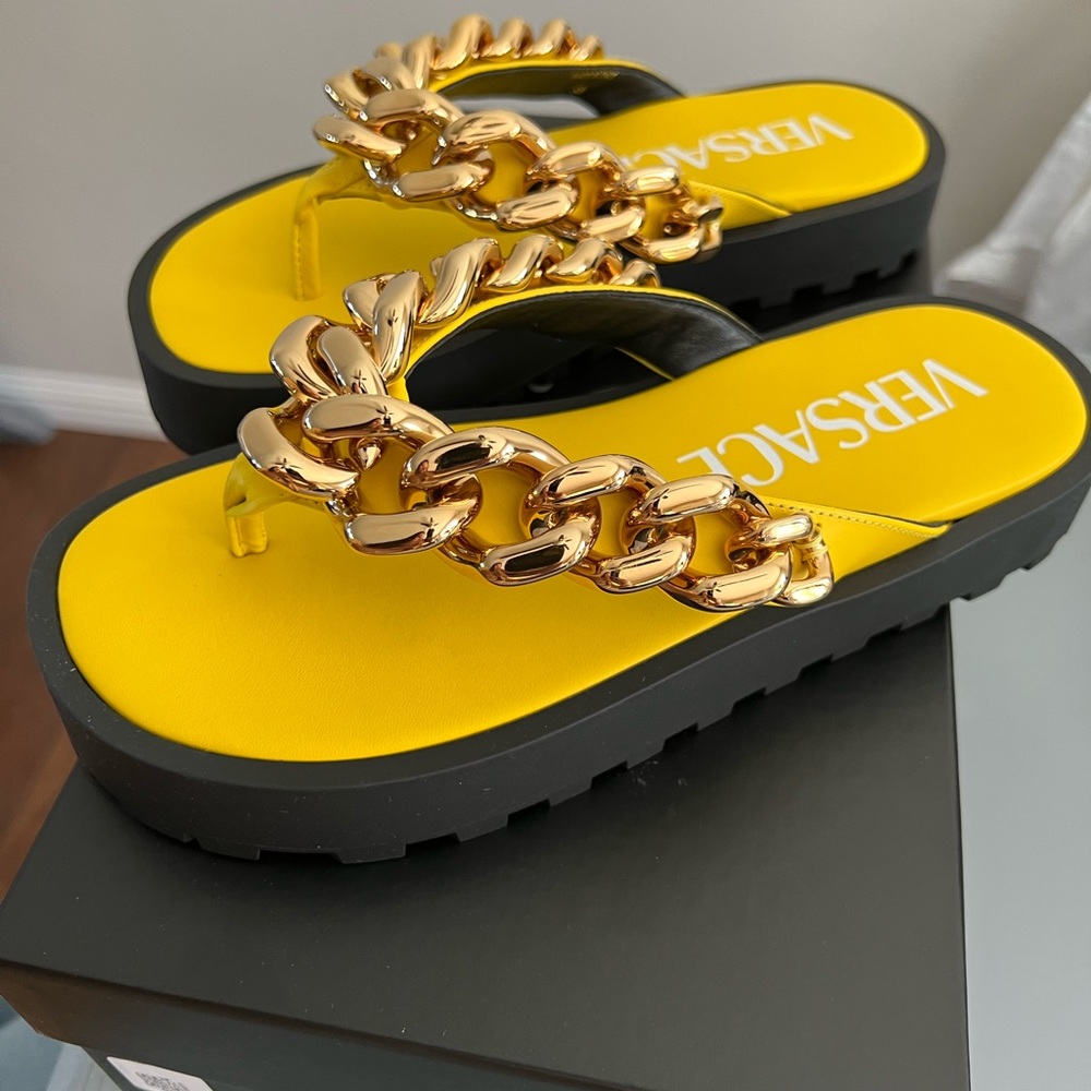Versace sandals .Never worn .Black and yellow with gold chain detail .